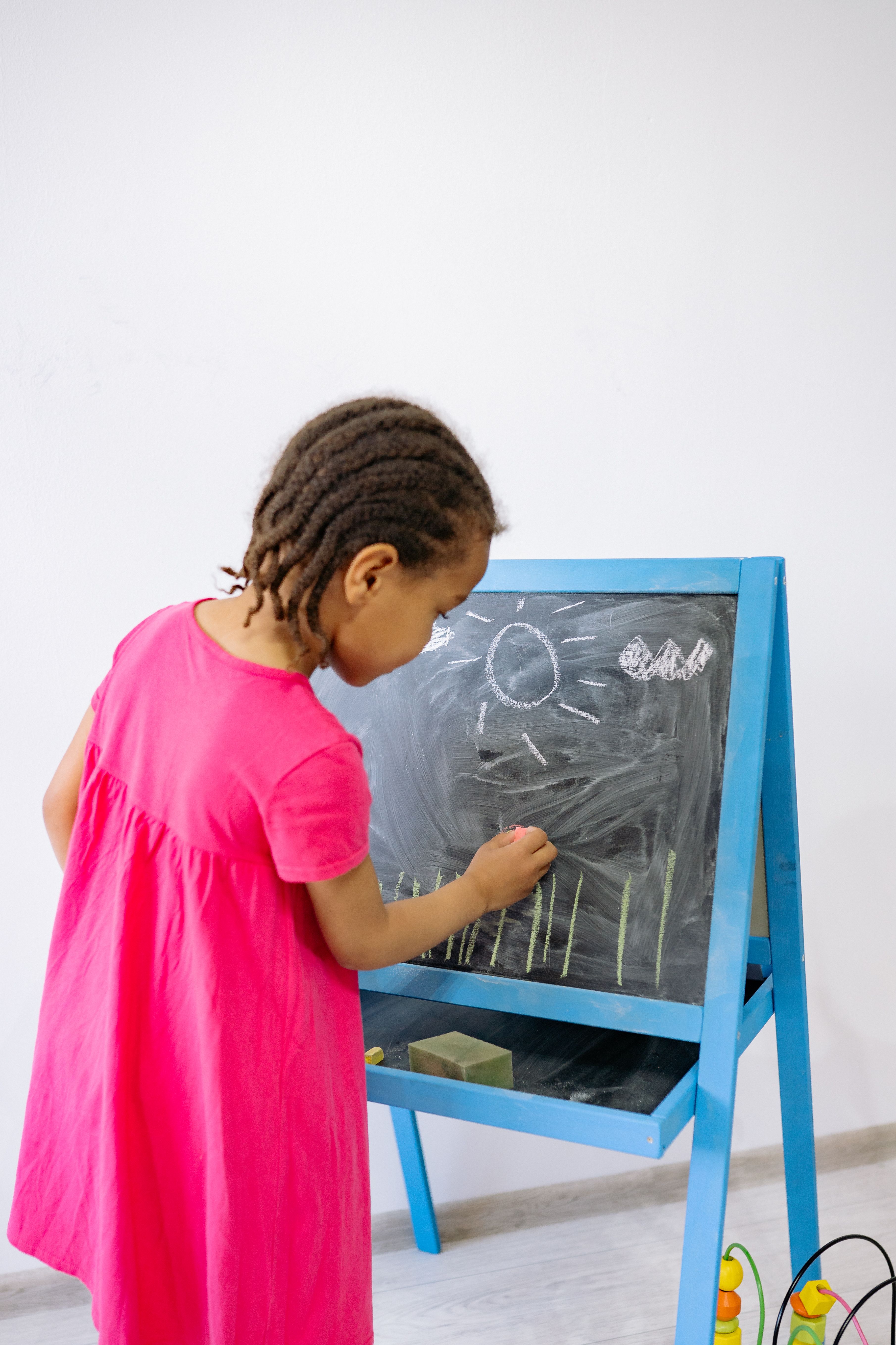 Child drawing at a board during a learning activity