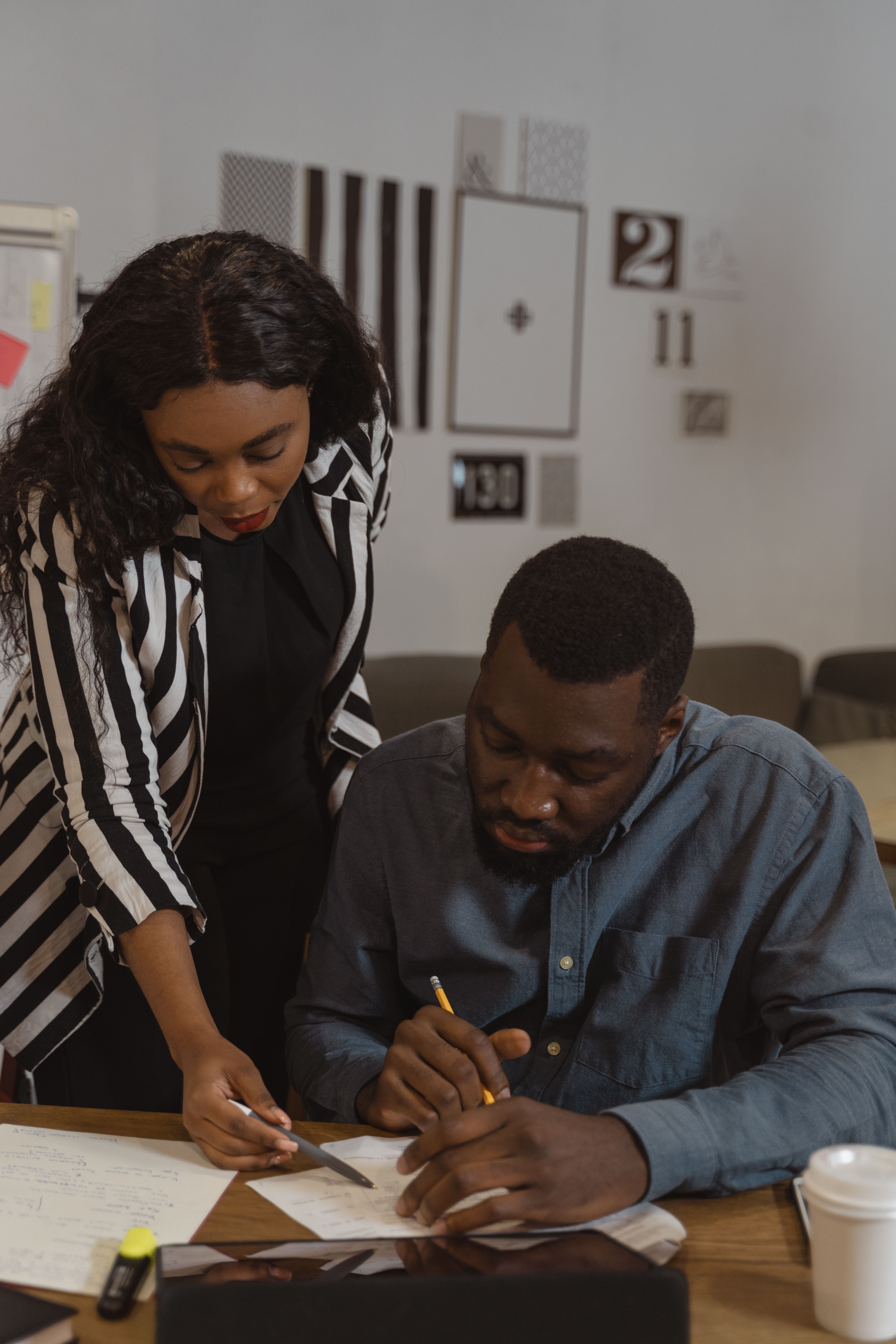 Mentor and trainee reviewing written notes together